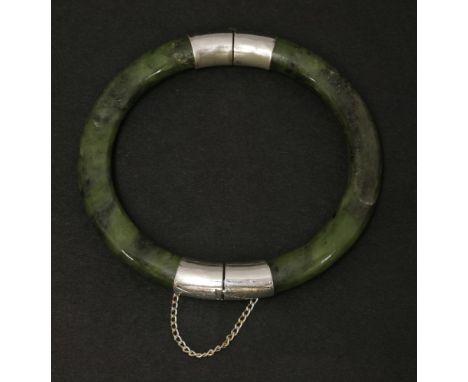 A spinach jade bangle, 20th century, of rounded form with metalwares hinge and clasp, 6.3cm inner diameter