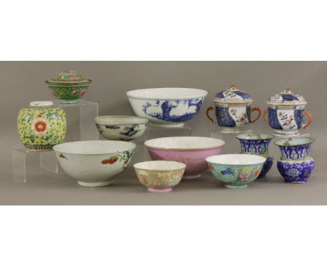 Canton enamel, c.1800, a pair of zhadou, a bowl and cover, and a pair of bouillon cups and covers with flowers on a dark-blue
