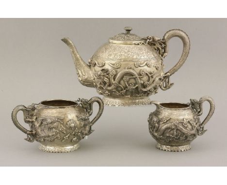 A silver three-piece Tea Set, c.1900, of circular form on a circular foot with ruyi head clouds, each decorated with two oppo