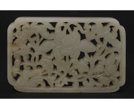 A jade openwork Plaque,18th/19th century, of rectangular form carved with flowering blooms emerging from rockwork, the stone 