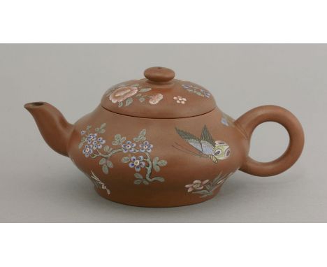 A Yixing Teapot,Daoguang (1821-1850), of discus form, well enamelled with butterflies, flowers and a bird in a prunus branch,