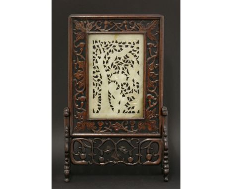 A rectangular jade Panel,early 20th century, pierced and carved in Ming style with a flowering tree, and a crane perched on r