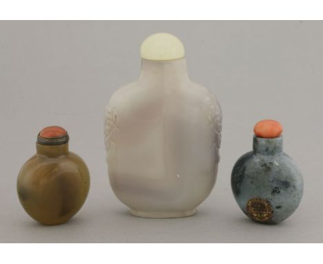 An agate Snuff Bottle,late 18th century, of plain flask form in grey-blue, with coral stopper,5.5cm, andtwo further agate Snu