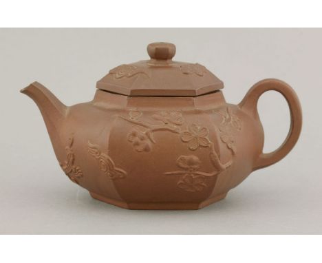 An attractive small Yixing Teapot and Cover,mid-18th century, the hexagonal depressed onion body sprigged with prunus, clouds