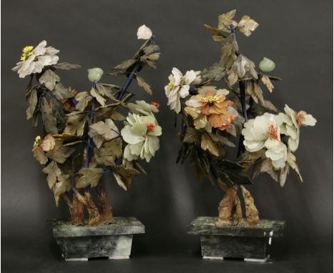 A pair of hardstone flowering Peonies,early 20th century, each bloom carved from jade or agate and with soapstone leaves from