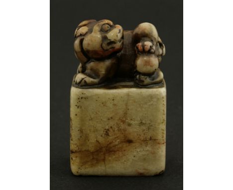 A soapstone seal, 20th century, carved with a Buddhist lion playing with a ball, inscribed and dated May, year of yiyou, seal