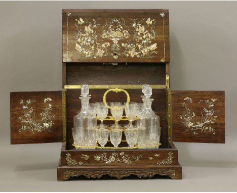 An exceptional Drinks Cabinet,late 19th century, of box form, the rosewood meticulously inlaid in mother-of-pearl with a prof