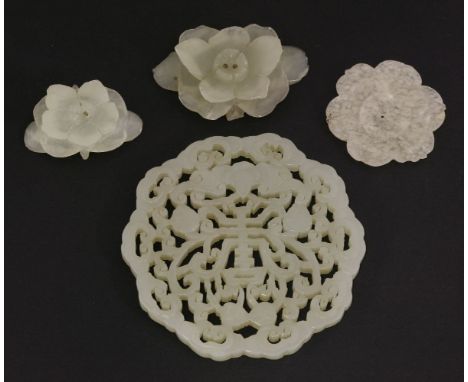 A jade Pendant,19th century, pierced and carved with a shou surrounded by a bat and four peaches with a ruyi head cloud borde