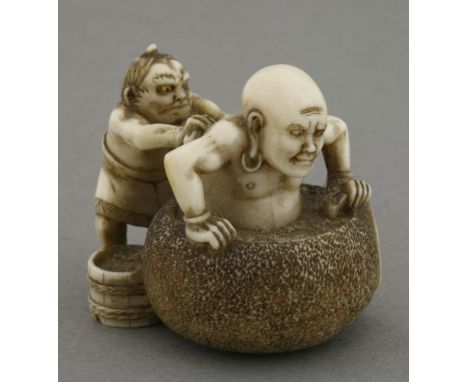 An fine ivory Netsuke,c.1870, of an immortal half submerged in an hibachi serving as a bath while an oni scrubs his back, the