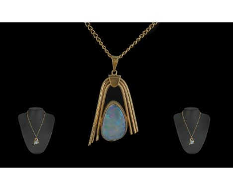 A Fine Quality 9ct Gold Opal Set Pendant. The Large Opal of Excellent Colours. Est Weight 8.00 cts. Attached to a 9ct Gold Ch