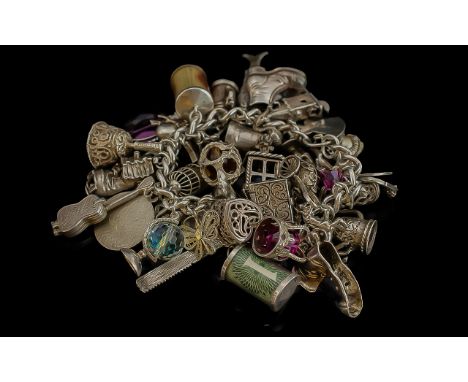 A Vintage Excellent Quality Sterling Silver Bracelet Loaded with Over 40 Charms. Some Interesting and Better Quality Charms, 