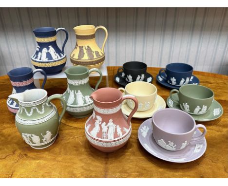 Wedgwood Collection comprising five assorted coloured cups and saucers and six assorted coloured jugs, classical designs. Chi