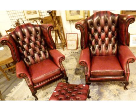 Two red leather button back Chesterfield chairs
