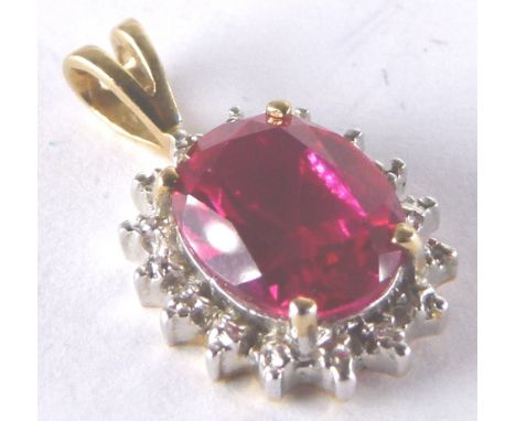 9 ct gold ruby pendant with diamonds surrounding H: 21 mm