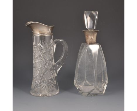 Cut glass jug, silver collar with import marks, height 28cm; also a silver mounted decanter with stopper. (2)