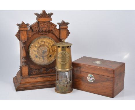 An oak cased shelf clock with American Ansonia movement, brass arabic dial with twin train movement striking on a gong, with 