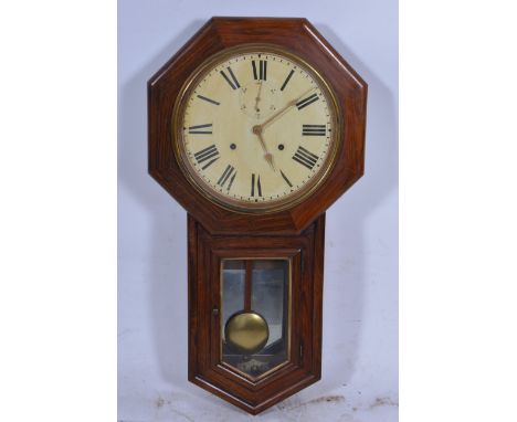 An oak cased wall clock, 28cm roman numeral dial with subsidiary seconds dial in an octagonal case with glazed aperture to tr