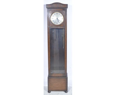 Oak longcase clock, 1940s, arched pediment, 9.5" circular silvered dial with silent chime indicator, glazed door, bun feet, t