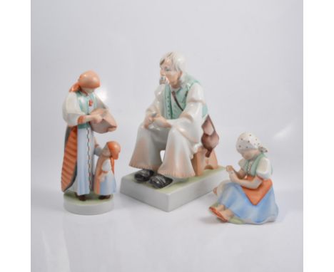 Large Zsolnay Pecs porcelain figure, seated man, 34cm; another large figure of a woman and child; and another of a girl feedi