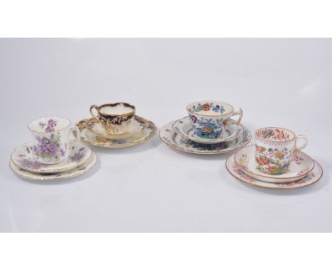 Selection of cups, saucers and plates, to include George Jones trio decorated with flowers with blue and gold surround c1900,