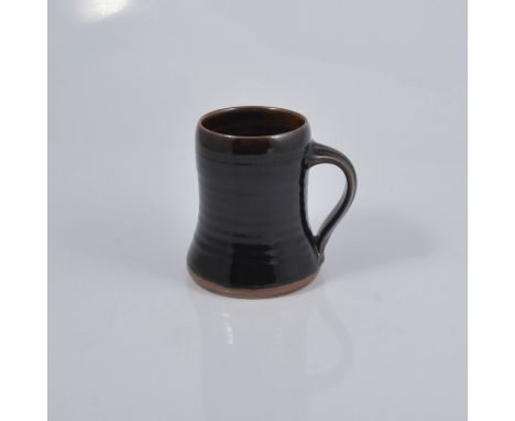 Harry and May Davis at Crowan Pottery, a studio pottery tankard, tenmoku glaze, impressed seal mark, 13.5cm high