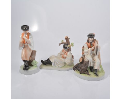 Zsolnay Pecs figure, a man playing a pipe, 27cm; two other similar models. (3)