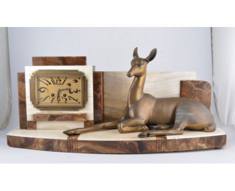 French, an Art Deco onyx and marble mantel clock, with seated metal fawn alongside a stylised rectangular gilt dial, 66cm wid