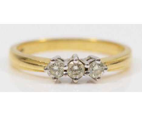 An 18ct gold three stone brilliant cut diamond dress ring, Q, 3.8gm. 