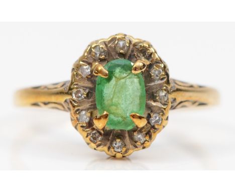 A 9ct gold emerald and eight cut diamond dress ring, L, 1.6gm.There is a nibble to one end of the stone, see image, needs cle