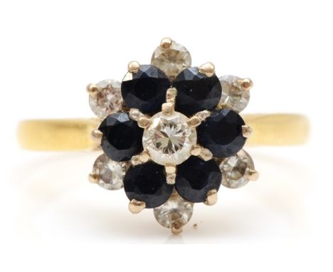 An 18ct gold sapphire and brilliant cut diamond cluster ring, estimated center diamond weight .15, N-O, 4.2gm. 