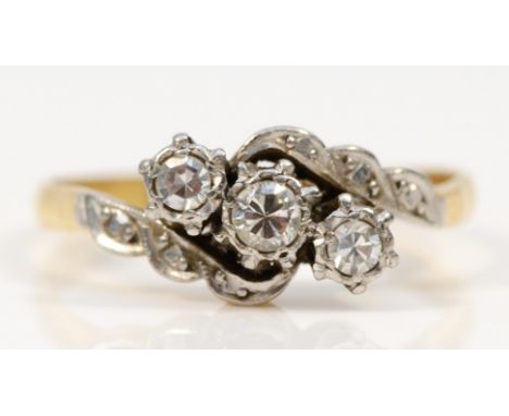 An 18ct gold a platinum set three stone diamond dress ring, with old cut and eight cut diamonds, Q, 3.3gm. 