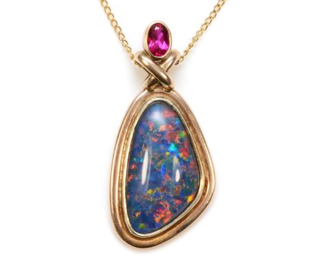 A 9ct gold opal triplet and synthetic ruby pendant, on a 9ct gold chain, 41 x 19mm, 8.1gm. 