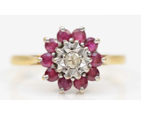 An 18ct gold ruby and brilliant cut diamond cluster ring, R-S, 3.5gm. 