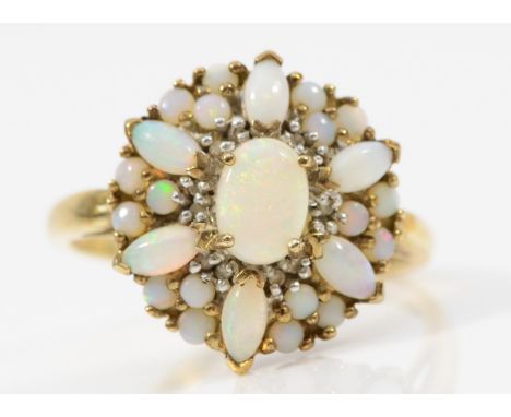 A 9ct gold opal floral cluster ring, flashes of red and green, T, 3.7gm. 