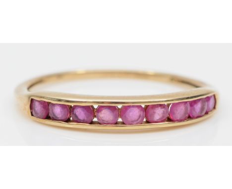 A 9ct gold channel set pink sapphire dress ring, S-T, 1.4gm. 