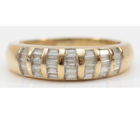 A 9kt gold seven row baguette cut diamond dress ring, stated weight .50, R, 4gm. 