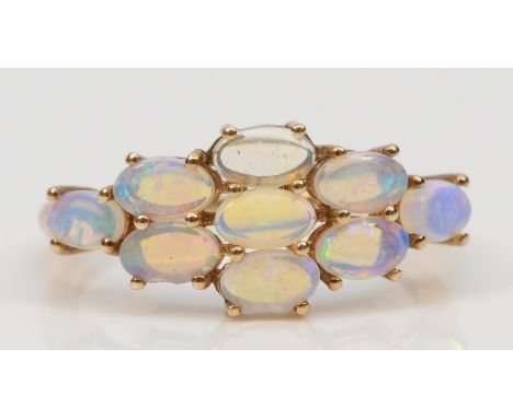 A 9ct gold crystal opal cluster ring, flashes of green, blue and yellow, O, 1.8gm. 