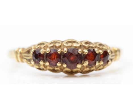 A 9ct gold graduating five stone garnet dress ring, N-O, 1.3gm. 