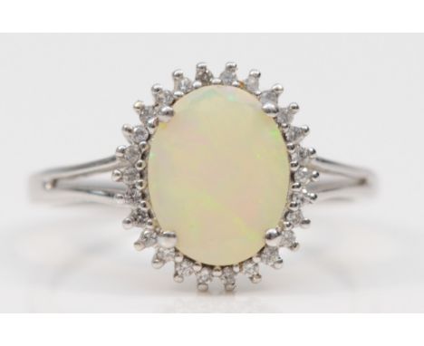 A 9ct white gold synthetic opal and white stone dress ring, O, 2.4gm. 