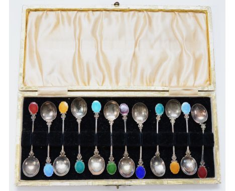 A set of twelve early 20th century continental silver and enamel tea spoons, cased, 60gm. 