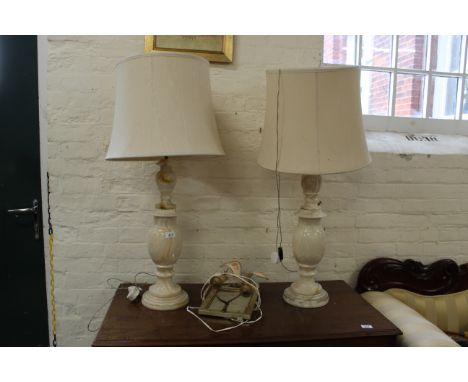 A pair of large onyx table lamps and a two branch mirror back wall light