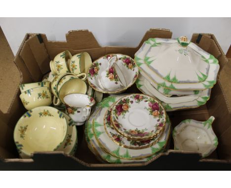 An Art Deco Scotch Ivory part dinner service including two tureens plus a part Mintons tea service and Royal Albert cups and 