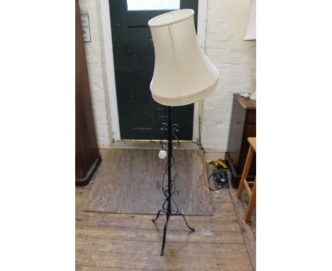 A wrought iron standard lamp