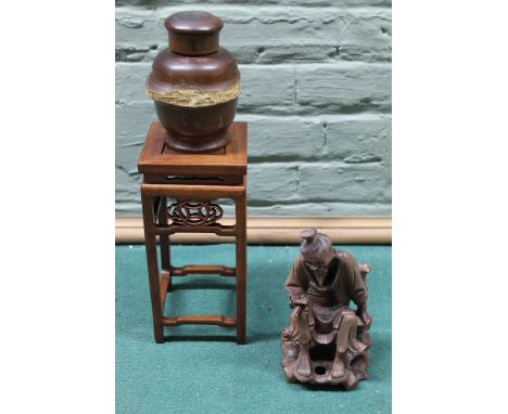 Three Oriental carved wooden items including a tea caddy, a miniature stand and a seated figure with a pipe