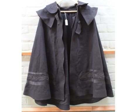 An antique cloak, possibly for a coach driver, raised detail around the middle (lacking one button and wear to collar)