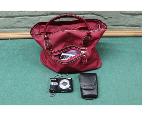 An Olympus X-44 digital camera with a bag of accessories