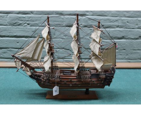 Vintage wooden model of HMS Victory in full sail, approx 5cm long