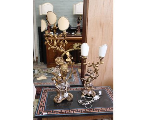 Two Venetian style gilded table lamps in the form of cherubs supporting a two and three branch light