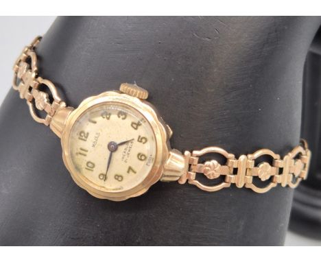 9ct yellow gold cased ladies watch fitted with a rolled gold bracelet. Majex incabloc 21 jewels. 