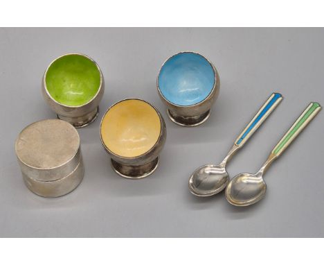 Selection of silver and enamel items; Three 835 silver and enamel egg cups. Two 925S Silver and enamel coffee spoons and Fore
